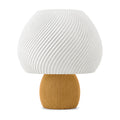 Abajur de mesa com cúpula branca em formato de cogumelo com nervuras em espiral e base canelada caramelo, em fundo branco